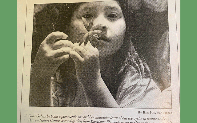 A newspaper article featuring a girl joyfully holding a flower, symbolizing growth and new beginnings.