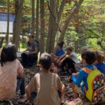 Students gather around to listen to environmental educator