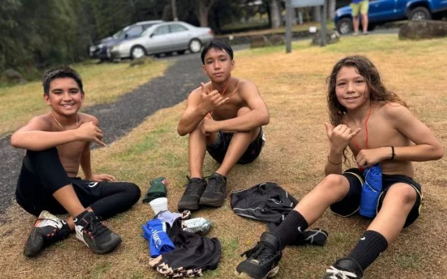 three boys sitting after the Rain forest Ramble fundraiser