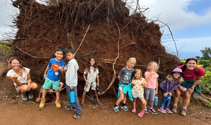 Maui kids by upturned tree rootslearning and having fun at a Hawai‘i Nature Center program