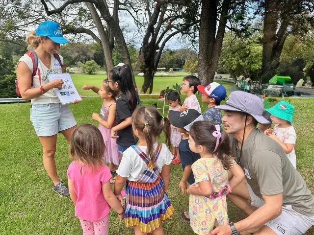 children gathering around instructor